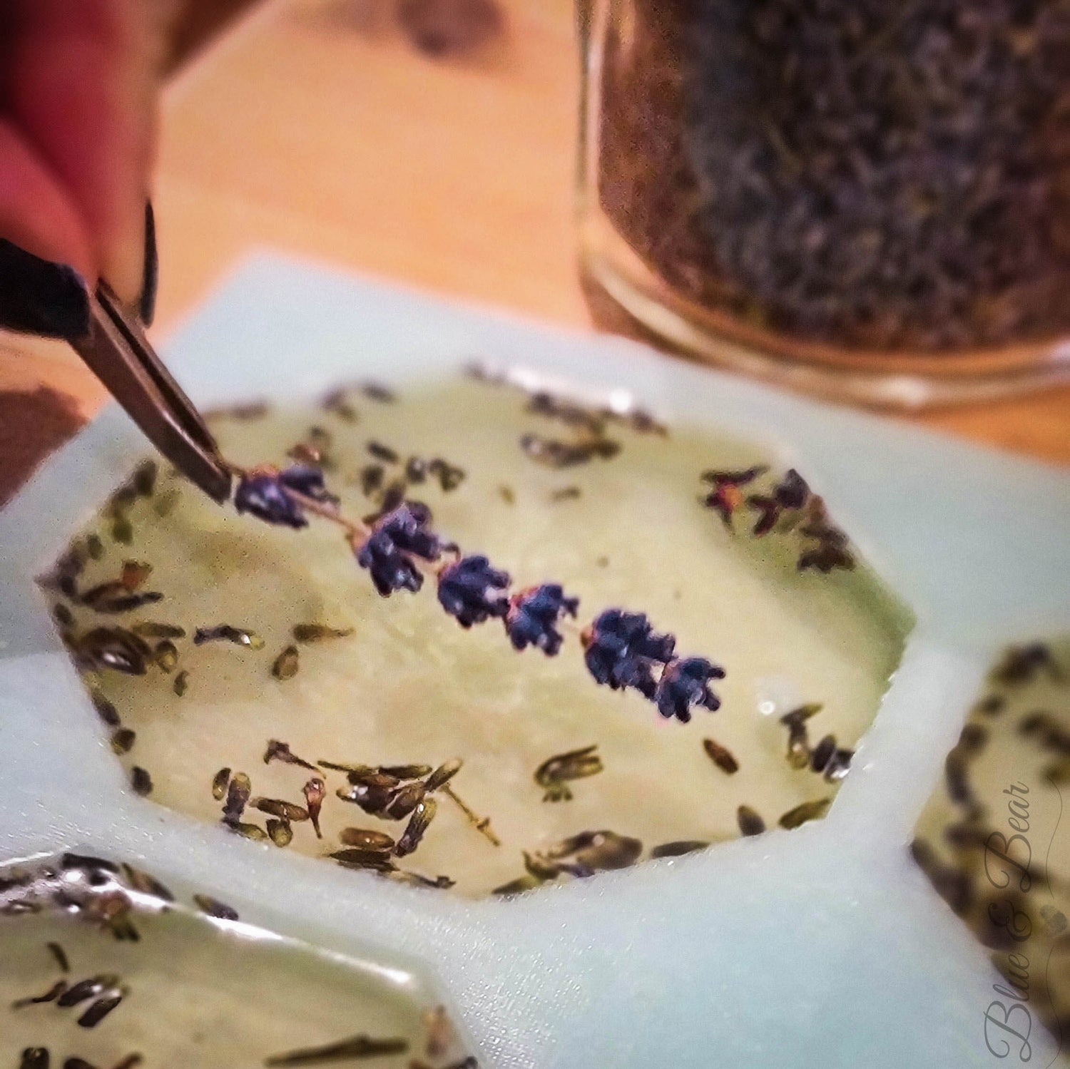 Ruth, the owner of Blue & Bear, carefully placing Lavender stems into the Soy Wax of a BREATHE Botanical Palette.  All Blue & Bear Products are hand-crafted in small batches.