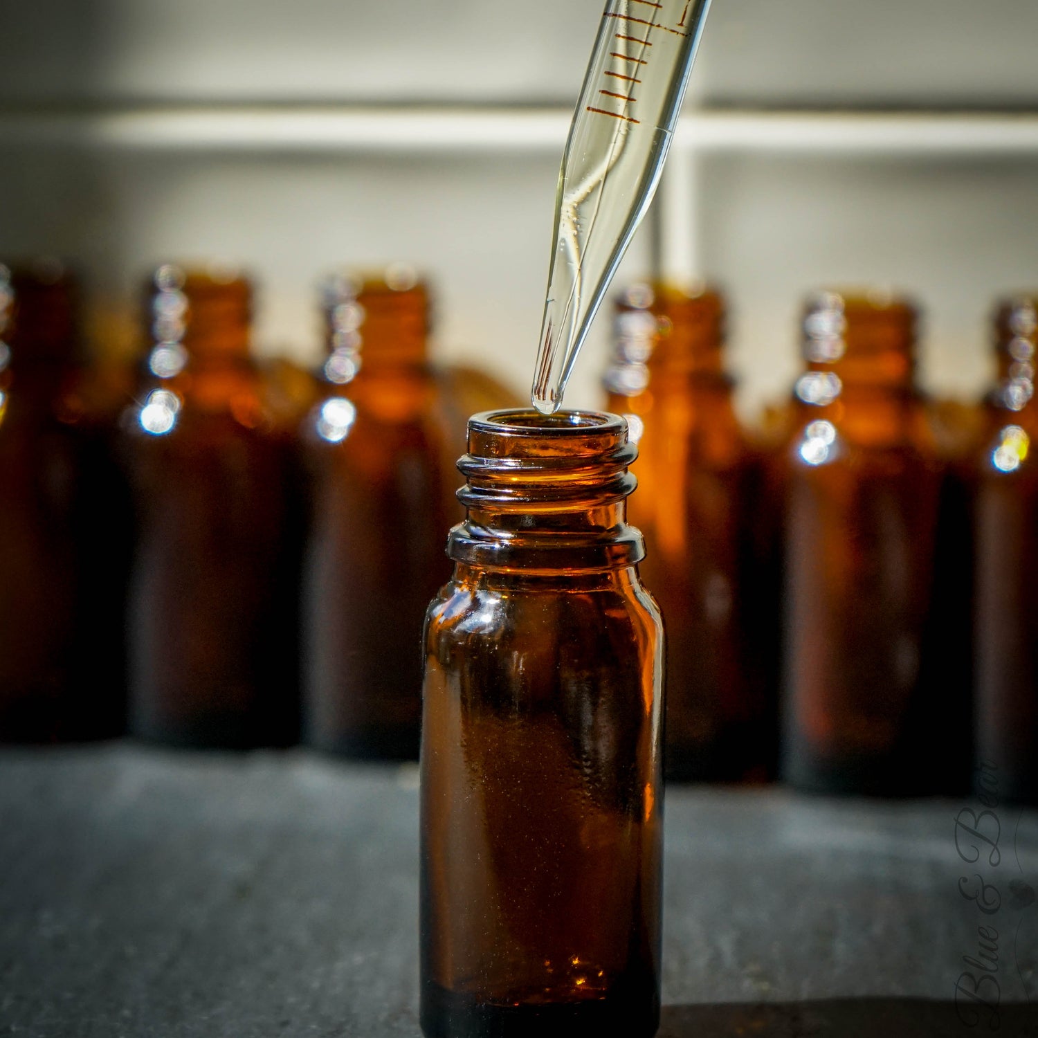 An empty dripper bottle being filled with essenital oil from a pipette.  All Blue & Bear Pure Essential Oils Blends are hand-poured in our Cotswold workshop.
