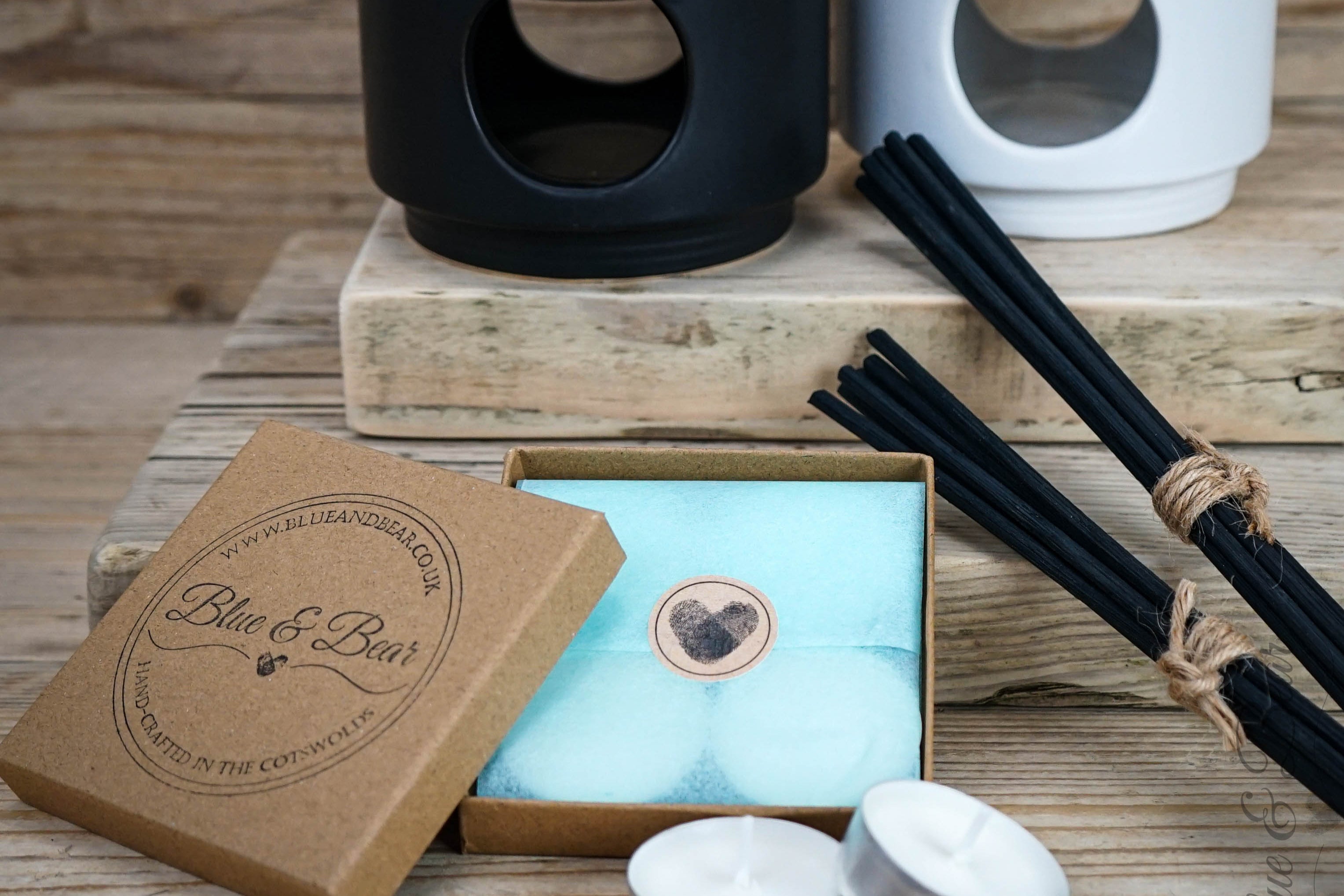 A range of accessories to accompany Blue & bear's essential oil products, arranged on a wooden surface