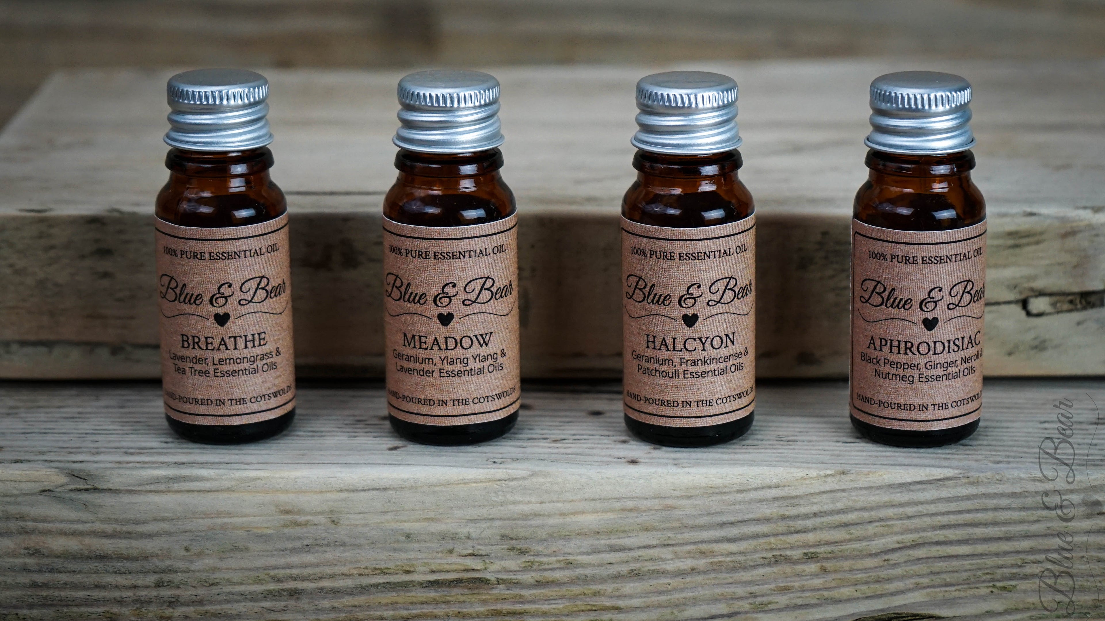 Four 10g dropper bottles of Blue & Bear Pure Essential Oil Blends in a row against a wooden background.  Luxury oils, with numerous uses to fragrance your home