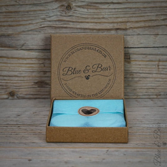 A set of four natural wax tea lights from Blue & Bear wrapped in tissue paper and a heart sticker inside a kraft box.  Perfect for use with our essential oil products.