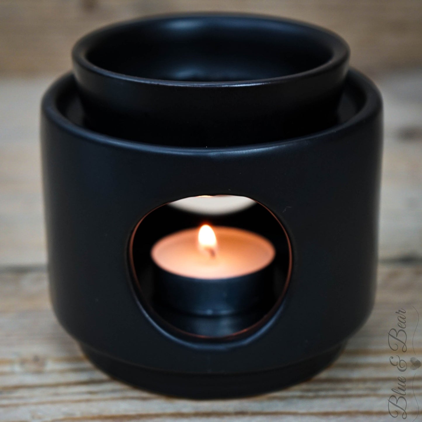 Black Ceramic Wax and Oil Burner from Blue & Bear with a tea light burning inside.  Perfect for using with Botanical Palettes and Pure Essential Oils. 